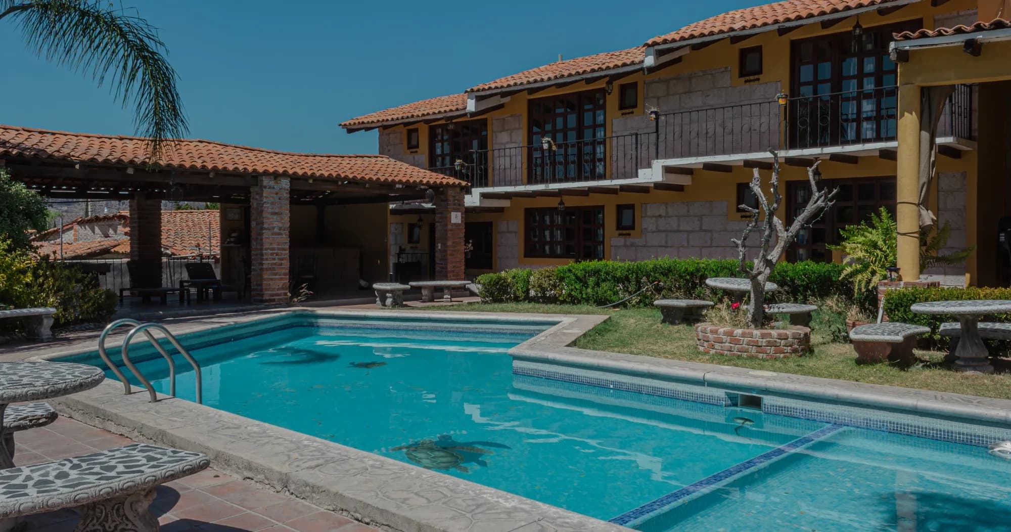 Alberca y edificio del hotel de Cabañas Los Pocitos